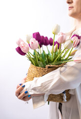 Portrait of a smiling middle aged woman with tulips on a white background