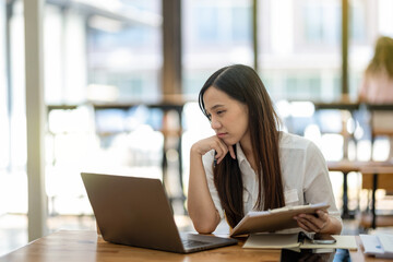 Business employee working with laptop, thinking of plan, project management, considering new...