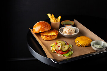 One tasty burger with cheese ingredients and coleslaw salad on tray