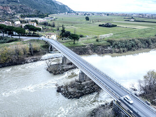 Aerial view of a bridge over the Arno river with the passage of cars, Pisa, Tuscany - 722043166