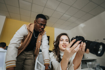 Woman taking picture with camera at work. She is showing a picture to her male colleague at the office.
