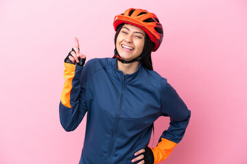 Teenager cyclist girl isolated on pink background showing and lifting a finger in sign of the best - obrazy, fototapety, plakaty