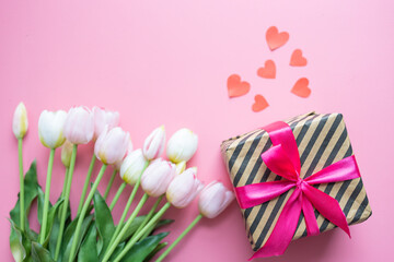 Tulips and gift box on pink background flat lay top view. Woman's day, love concept, valentine's day holiday, date, romance. 