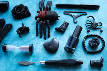 a blue background with various black items and a spider