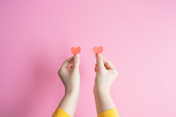Demonstration of love. female hands are holding two red hearts. hands get likes on social networks....