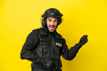 SWAT caucasian man isolated on yellow background making guitar gesture