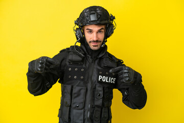 SWAT caucasian man isolated on yellow background proud and self-satisfied