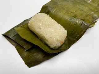 Lemper, is a snack made from glutinous rice, filled with chicken floss, wrapped in banana leaf