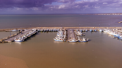 Fishing boats in the harbor of Mazara del Vallo in Sicily on 2021, aerial view