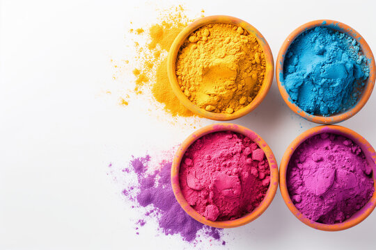 Vibrant indian holi festival color powders in four bowls on white background. Concept of colorful gulal, celebration, and cultural.