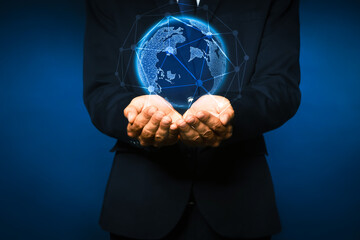 Global innovation. Businessman holding virtual planet on dark blue background, closeup