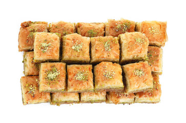 Delicious fresh baklava with chopped nuts isolated on white, top view. Eastern sweets