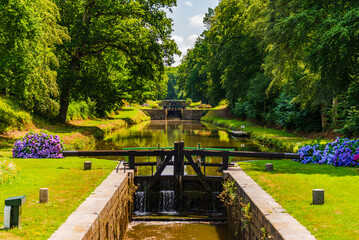 Tourist site of the Ille-et-Rance canal, The eleven locks, in H&eacute;d&eacute; Bazouges, between Saint-Malo and Rennes. The lock keepers maintain the surroundings and make many flower screens bloom.