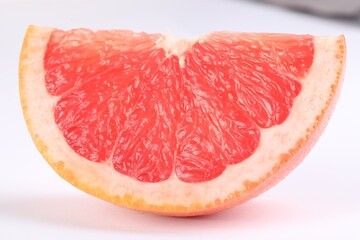 Cut ripe grapefruit isolated on white. Citrus fruit