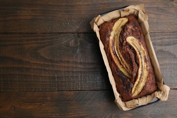 Delicious banana bread on wooden table, top view. Space for text