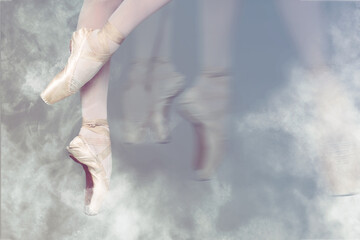 Perfection in ballet. Woman dancing in pointe shoes on grey background, closeup. Motion effect with...