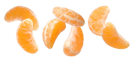 Pieces of fresh ripe tangerine falling on white background