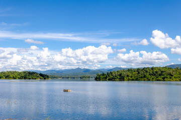 Kiew Kho Ma Dam with big mountain and forest, Wide lake with blue sky and white puffy clouds background, Located on Ban Huai Sanao Village, Pong Don, Chae Hom District, Lampang, Northern of Thailand.