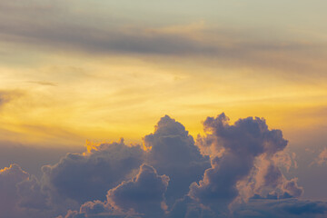 Beautiful golden yellow sky and white grey cloud, Cumulus are clouds which have flat bases and are often described as puffy, Orange sky in evening during sunset, Nature background with free copy space