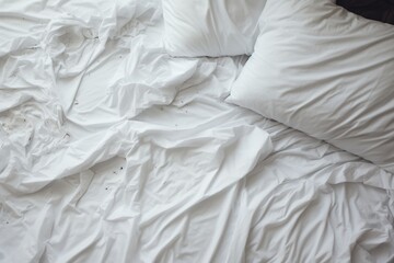 white sheet and pillows on the bed.