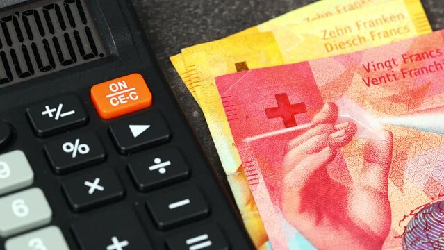 Switzerland money, Taxes and financial settlements, Business and economic concept, Calculator and deductible Swiss francs, budget and expenses