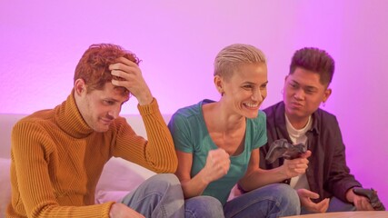 Woman winning a console game with friends at home