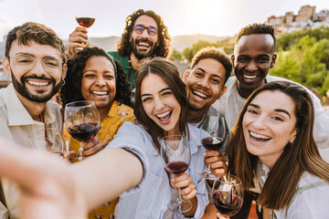 Multiracial friends drinking red wine outside at farm house vineyard countryside - Group of young...