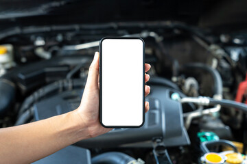 A woman uses a mobile phone to take a picture of the engine