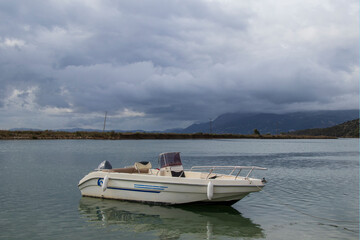 boat in the sea against the backdrop of mountains in Albania, Albanian landscapes