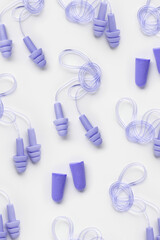 Different earplugs as minimal style pattern, comfort silicone and rubber ear plug on string protection against noise, protect hear, for swim, sleep, rest. Top view flat lay photo pattern