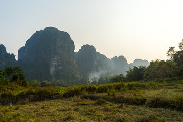 Serene landscape of a lush valley with towering karst formations