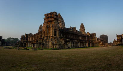 Panoramic view of the ancient Angkor Wat temple complex at sunset