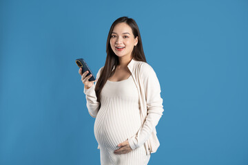 Portrait of pregnant asian woman, isolated on blue background