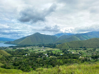 Naklejka premium Lake Toba of north Sumatra against cloudy sky taken from Dolok Raja.