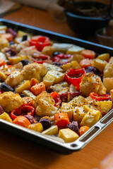 Close up image of a delicious and healthy looking tray with roasted colourful root vegetables fresh from the oven in a sunlit kitchen