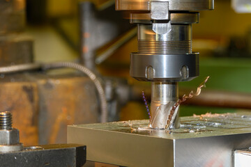 The plunge cutting  process on NC milling machine with flat end mill tools.