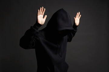 Boy in Black Hood raising his hands up to be arrested