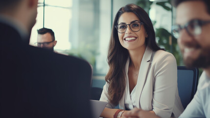 Fototapeta premium Colleagues foster teamwork in a well-lit, friendly office space.