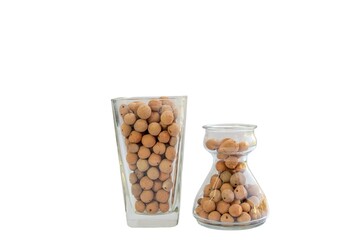 Baked clay balls for indoor plants in glass vases on white isolated background