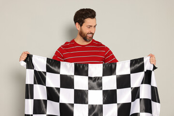 Man with checkered flag on white background - obrazy, fototapety, plakaty