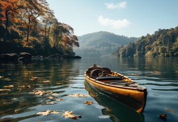 A lone canoe glides peacefully across the tranquil lake, guided by the steady strokes of a paddle as it navigates through a breathtaking landscape of towering trees and majestic mountains under a cle