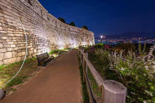 Korean cityscape at night at Naksan Park with Ancient Walls in Seoul, South Korea.