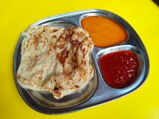 Closeup image of a flatbrea or also called "roti Canai" in Malaysia. Malaysian favourite meal for breakfast. served with a curry, dhal or spicy sambal for dipping