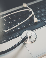 Stethoscope on laptop keyboard. Health care, remote medical examination. Healthcare business concept