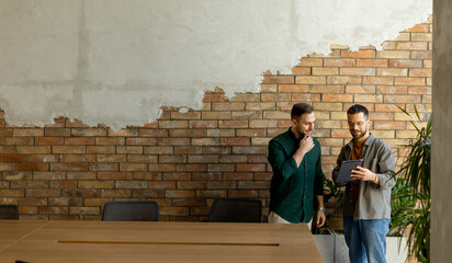 Collaborative Discussion in a Modern Office With Exposed Brick Walls