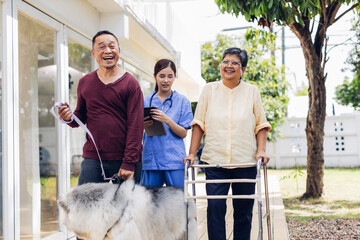 Caregiver nurse take care a Senior patient walking in park. Nurse helping senior Woman outside...