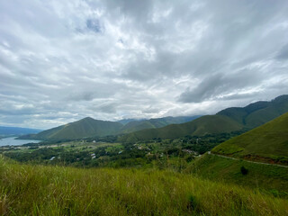 Fototapeta premium Cloudy Sky Against The Lake. Lake Toba taken from Dolok Raja Hills, North Sumatra.