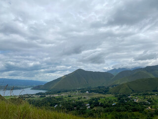 Fototapeta premium Cloudy Sky Against The Lake. Lake Toba taken from Dolok Raja Hills, North Sumatra.
