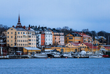 Fototapeta premium Bustling Harbor With Numerous Boats Next to Tall Buildings in Sweden