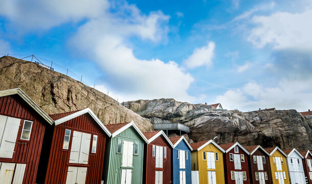 Colorful Beach Huts Next to Swedens Majestic Mountain